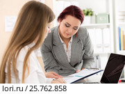 Two female auditors looking at financial report. Стоковое фото, фотограф Людмила Дутко / Фотобанк Лори