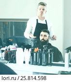 client feeling discontent about his new haircut at hair salon. Стоковое фото, фотограф Яков Филимонов / Фотобанк Лори