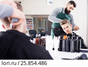 client feeling discontent about his new haircut at hair salon. Стоковое фото, фотограф Яков Филимонов / Фотобанк Лори