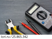Multimeter and side cutters on a dark wooden background. Стоковое фото, фотограф Alexander / Фотобанк Лори