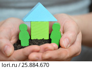 Female hands holding a piece of land with wooden house. Ecological home, family, construction and real estate concept. Стоковое фото, фотограф Сергей Дорошенко / Фотобанк Лори