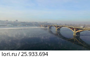 Аэрофотосъемка с воздуха. Зима. Город Иркутск. Россия. Сибирь. Вид на мост через реку Ангара (2017 год). Стоковое видео, видеограф Виталий Зверев / Фотобанк Лори