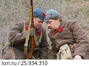 Volgograd, Russia - November 21, 2010: Portrait of re-enactors dressed as Russian Soviet Soldier of World War II in military-historical reconstruction in Volgograd. The battle of Stalingrad. Редакционное фото, фотограф Юлия Олейник / Фотобанк Лори