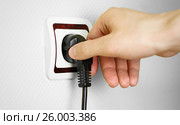 Male hand puts plug in the socket, closeup shot. Стоковое фото, фотограф Плотников Дмитрий / Фотобанк Лори