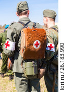 Unidentified re-enactors dressed as German military paramedic with a red cross brassard and medical bag. Стоковое фото, фотограф FotograFF / Фотобанк Лори