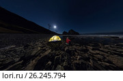 Panorama of man at tent on stone beach on shore of Lake Baikal at night. Стоковое фото, фотограф Zakirov Aleksey / Фотобанк Лори