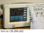 Modern oscilloscope, man's hand adjusting wave signals, closeup. Стоковое фото, фотограф Сергей Дорошенко / Фотобанк Лори
