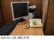 Soviet retro phone with the emblem of the USSR is on the desktop in the office. Стоковое фото, фотограф Мила Демидова / Фотобанк Лори