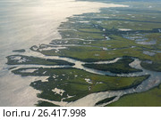 Coast of the Kamchatka Peninsula is cut by water arteries of Pacific Ocean. View from plane. Стоковое фото, фотограф Юлия Машкова / Фотобанк Лори