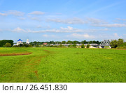 Bogolyubovo, spring landscape with a church, a green meadow and a high-speed train (2013 год). Редакционное фото, фотограф Анна Мартынова / Фотобанк Лори