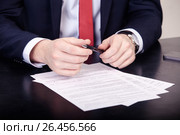 Business agreement signing, businesswoman handwriting signature on contract document at office desk. Стоковое фото, фотограф Артём Зайцев / Фотобанк Лори