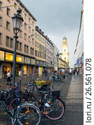 MUNICH, GERMANY - May 29, 2012: bicycles on the street Theatinerstrasse with view onTheatine Church of St. Cajetan (Theatinerkirche St. Kajetan) Редакционное фото, фотограф Куликов Константин / Фотобанк Лори