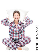 Woman in pajamas sitting on white background with pillow under head isolated. Стоковое фото, фотограф Константин Лабунский / Фотобанк Лори