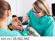 Terrified client in dental clinic. Стоковое фото, фотограф Яков Филимонов / Фотобанк Лори
