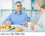 Wife and husband are discussing and studying important contract. Стоковое фото, фотограф Яков Филимонов / Фотобанк Лори