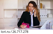 Young and smiling woman office worker talking on the phone. Стоковое видео, видеограф Яков Филимонов / Фотобанк Лори
