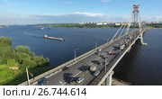 Вид сверху на Октябрьский вантовый мост через реку Шексна, баржа проходит под мостом. Череповец (2017 год). Редакционное видео, видеограф Кекяляйнен Андрей / Фотобанк Лори