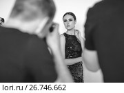 Photographers paparazzi take photos of woman in cocktail dresses. Стоковое фото, фотограф Женя Канашкин / Фотобанк Лори
