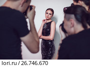 Photographers paparazzi take photos of woman in cocktail dresses. Стоковое фото, фотограф Женя Канашкин / Фотобанк Лори