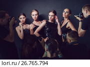 Photographers paparazzi take photos of women in cocktail dresses on dark background. Стоковое фото, фотограф Женя Канашкин / Фотобанк Лори