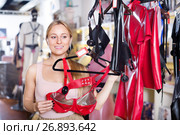 Woman selecting sexy underwear in sex shop. Стоковое фото, фотограф Яков Филимонов / Фотобанк Лори