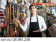 male seller posing at tooling section of household store. Стоковое фото, фотограф Яков Филимонов / Фотобанк Лори