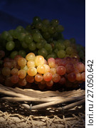 Juicy fresh red and white grapes in a wattled basket. Стоковое фото, фотограф ElenArt / Фотобанк Лори