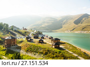 Tourist complex on the shore of the largest in the North Caucasus high mountain lake Kezenoy-Am. Туристический комплекс на берегу самого большого на Северном Кавказе высокогорного озера Кезеной-Ам летом (2017 год). Редакционное фото, фотограф Jon Maldini / Фотобанк Лори