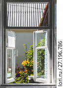 View from an old rural window in a sunny summer courtyard. Стоковое фото, фотограф Tetiana Chugunova / Фотобанк Лори