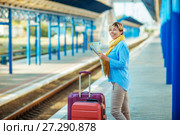 Young female waiting for the train at the railway station. female with suitcases. Стоковое фото, фотограф Наталья Давыдова / Фотобанк Лори