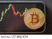 Bitcoin gold coin and chart background. Стоковое фото, фотограф Иван Карпов / Фотобанк Лори