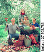 Happy family with harvest in garden. Стоковое фото, фотограф Яков Филимонов / Фотобанк Лори