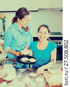 Two laughing women making pies. Стоковое фото, фотограф Яков Филимонов / Фотобанк Лори