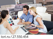 Couple consulting with assistent about color for sofa. Стоковое фото, фотограф Яков Филимонов / Фотобанк Лори