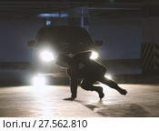 Man freerunner doing side flips in the garage, parkour acrobatic elements. Стоковое фото, фотограф Константин Шишкин / Фотобанк Лори