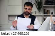 Young male struggling to pay utility bills and rent for his house. Стоковое видео, видеограф Яков Филимонов / Фотобанк Лори