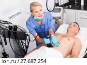 Female specialist is massaging with vacuum to belly of client for anti-fat. Стоковое фото, фотограф Яков Филимонов / Фотобанк Лори
