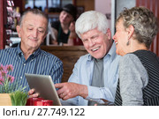 Cheerful Man in Coffee House using Tablet Computer. Стоковое фото, фотограф Scott Griessel / PantherMedia / Фотобанк Лори