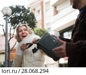 Burglar stealing bag of female pensioner. Стоковое фото, фотограф Татьяна Яцевич / Фотобанк Лори