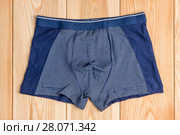 blue new cotton panties for boy clothes on wooden boards top view. Стоковое фото, фотограф Константин Лабунский / Фотобанк Лори