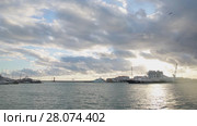 Panoramic view of Sochi sea port, Olympic rings in the sunset light, calm sea (2017 год). Стоковое видео, видеограф Ирина Мойсеева / Фотобанк Лори