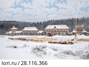 Wooden old-style buildings and logs in Russian Orthodox Monastery at winter day. Стоковое фото, фотограф Losevsky Pavel / Фотобанк Лори