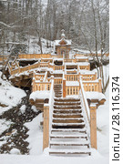 Wooden stairs with carving leading to fountain in Russian Orthodox Monastery at winter day. Стоковое фото, фотограф Losevsky Pavel / Фотобанк Лори