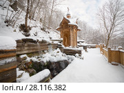 Wooden old-style structure and fountain in Russian Orthodox Monastery at winter. Стоковое фото, фотограф Losevsky Pavel / Фотобанк Лори