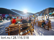 TSAGHKADZOR, ARMENIA - JAN 7, 2017: Resting skiers are in ski resort, Main winter resort of Armenia - Tsakhkadzor is located in picturesque valley near Tegenis mountain. Редакционное фото, фотограф Losevsky Pavel / Фотобанк Лори