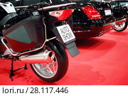 Black shiny bike for cortege, car are on red carpet in exhibition, back view. Стоковое фото, фотограф Losevsky Pavel / Фотобанк Лори