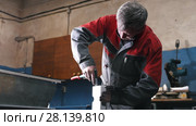 Worker assembling the metal part in the manual with a screwdriver. Стоковое видео, видеограф Константин Шишкин / Фотобанк Лори