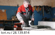 Worker assembling the metal part by hand with pliers, tools for grinding metal and metal details in the foreground. Стоковое видео, видеограф Константин Шишкин / Фотобанк Лори