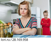 Upset girl and mother have a peeve on each other. Стоковое фото, фотограф Яков Филимонов / Фотобанк Лори