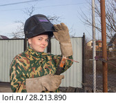 A young girl welder in working clothes. Стоковое фото, фотограф Олег Хархан / Фотобанк Лори